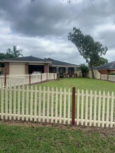 a white picket fence in front of a house at Private Rm3A in Elderslie in Elderslie