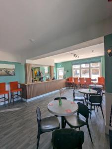 a restaurant with tables and chairs and a counter at Bar 21 in Hunstanton