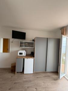 a kitchen with a refrigerator and a microwave at Rooms Raos in Brela +71 photos
