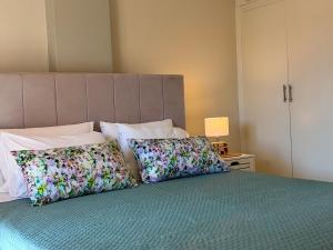 a bedroom with a bed with two pillows on it at Delta Apartment • next to the beach in Roda