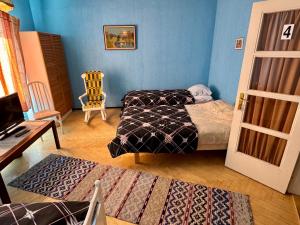 a bedroom with two beds and a table and a chair at Majatalo Tyrni in Nakkila
