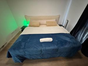 a bedroom with a large bed with a blue cover at Home Away From Home in Schönefeld
