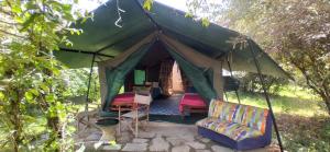 a gazebo with a couch and chairs in it at Best Camping Tours Campsite in Masai Mara