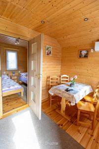 a room with a table and a bed in a cabin at Domki pod Żukowcem in Solina