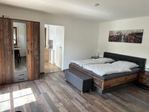 a bedroom with a large bed with a wooden frame at Fewo Susi Allgäu in Buchloe