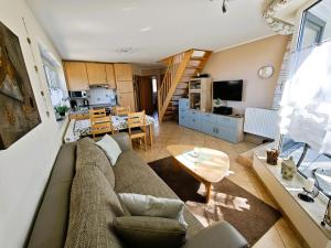 a living room with a couch and a table at Schulstrasse 10a Fewo in Zingst