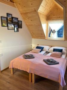 a bedroom with a large bed with two towels on it at Odskocznia2 in Maniowy
