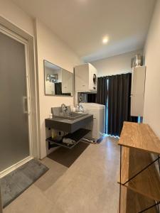 a kitchen with a sink and a refrigerator at Unite in Myoko in Taguchi +59 photos