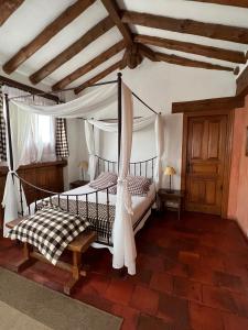 a bedroom with a bed with a canopy at La Tejera de Fausto in Requijada +53 photos