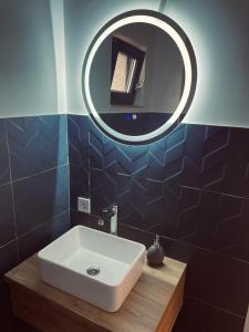 a bathroom with a white sink and a mirror at Flori de Tei Maramures in Săcel +39 photos