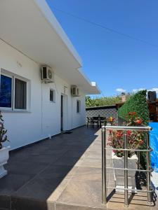 a patio of a house with flowers in a basket at Vila Eriseld in Ksamil