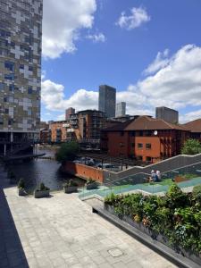 a view of a city with a river and buildings at Cozy One bedroom with Free Underground parking in Mailbox Birmingham city in Birmingham