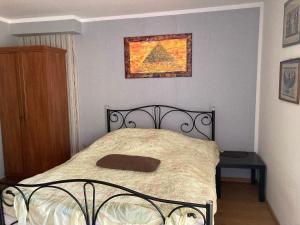 a bed in a bedroom with a picture on the wall at Słoneczny Set in Wólka Klucka