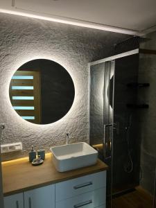 a bathroom with a sink and a mirror at Odskocznia2 in Maniowy