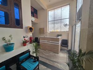 a living room with a desk and a dresser at Basuki Hotel in Jaipur