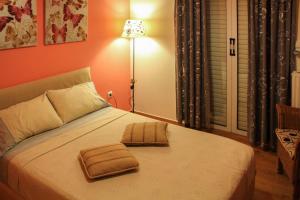 a bedroom with a bed with two towels on it at Ouranos Apartment in Athens