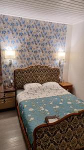 a bedroom with a bed with a floral wallpaper at Un moment d'évasion in Aulnoye-Aymeries