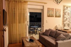 a living room with a couch and a table at Ouranos Apartment in Athens