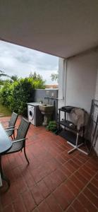 an outdoor patio with a table and a stove at Apartments Kavan in Barbariga