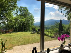 a window with a view of a field and mountains at Villa Aux Chênaies in Obernai