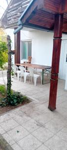 a patio with a table and white chairs at Vila Sofija in Vinci