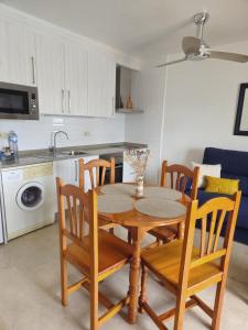 a kitchen with a wooden table and chairs in a room at Casa Indalo Vera Coast in Vera +26 photos