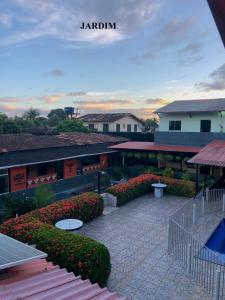 a view of a courtyard with flowers and a building at Pousada Aruanã in Soure