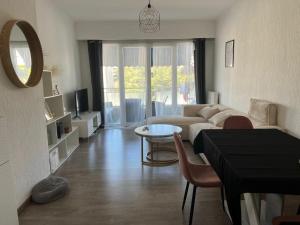 a living room with a couch and a table at Chambre d'hôte Cannes in Le Cannet