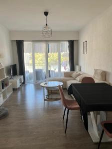 a living room with a couch and a table at Chambre d'hôte Cannes in Le Cannet