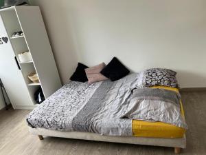 a bedroom with a bed with pillows on it at Chambre d'hôte Cannes in Le Cannet