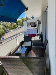 a balcony with chairs and a table and a street at Chambre d'hôte Cannes in Le Cannet