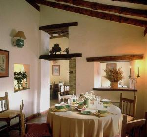 a dining room table with a white table cloth on it at La Tejera de Fausto in Requijada