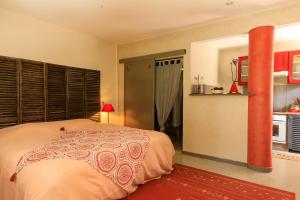 a bedroom with a bed and a red pole at Domaine de Rhodes - 5 Chambres et 7 locations de vacances in Avignon