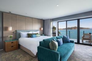 a bedroom with a large bed and a couch at The Inn Above Tide in Sausalito