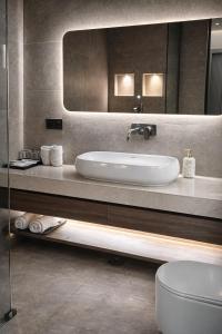 a bathroom with a sink and a mirror at The Cozy Chaos - Spa Jacuzzi -Private Terrace - Taj Mahal in Agra +65 photos