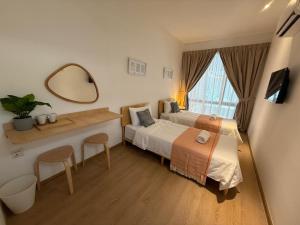 a hotel room with a bed and a mirror at ClubRock Perlis Signature Hotel in Kaki Bukit +49 photos
