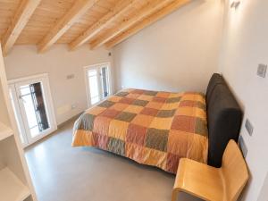 a bedroom with a bed and a chair in it at Mansarda Boutique May in Bergamo