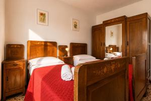 a bedroom with two beds and a mirror at Apartment Alex 1 in Domaso in Domaso