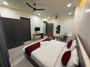 a bedroom with a large bed and a desk at RIVULET River Side Budget Business Class Hotel in Mukkam +64 photos