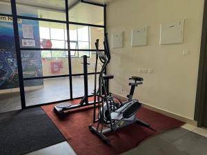 a room with a gym with a exercise bike at RIVULET River Side Budget Business Class Hotel in Mukkam