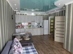 a kitchen with a couch and a table in a room at ЖК Хмельницький in Dnipro +5 photos