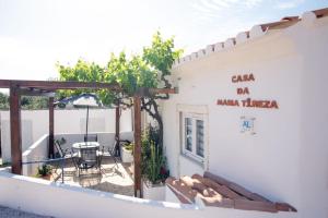 a balcony of a house with a table and chairs at Casa Da Maria - Villa with Private Pool and Barbecue in Fonte do Bispo