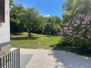 a view of a park with trees and flowers at Pension Victoria in Millstatt +7 photos