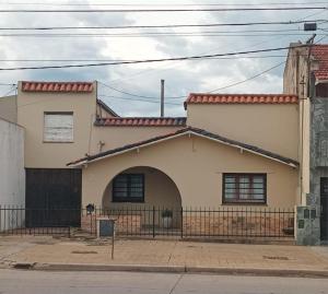 a house on the corner of a street at Dambofamily in Necochea