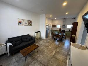 a living room with a couch and a table at Dambofamily in Necochea