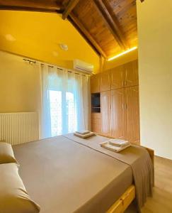 a large bed in a room with a window at Family Home in Amarynthos