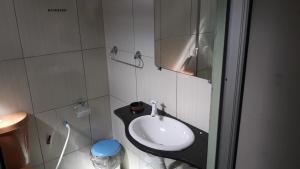 a bathroom with a sink and a mirror at Pousada Aruanã in Soure +16 photos