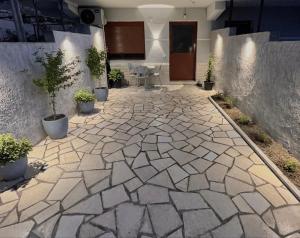 a stone courtyard with potted plants in a building at Floor Villa 2 in Vlorë