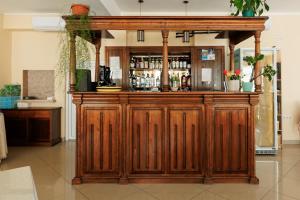 a large wooden bar in a room at Hotel Doina 2 Tasnad in Tăşnad