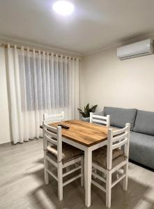 a dining room table with two chairs and a couch at Floor Villa 2 in Vlorë
